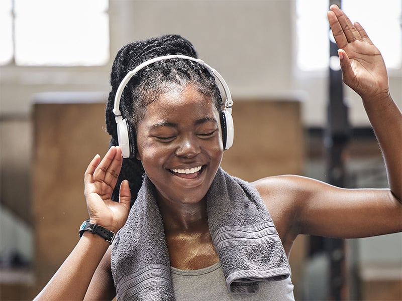 Woman vibing to music through headphones