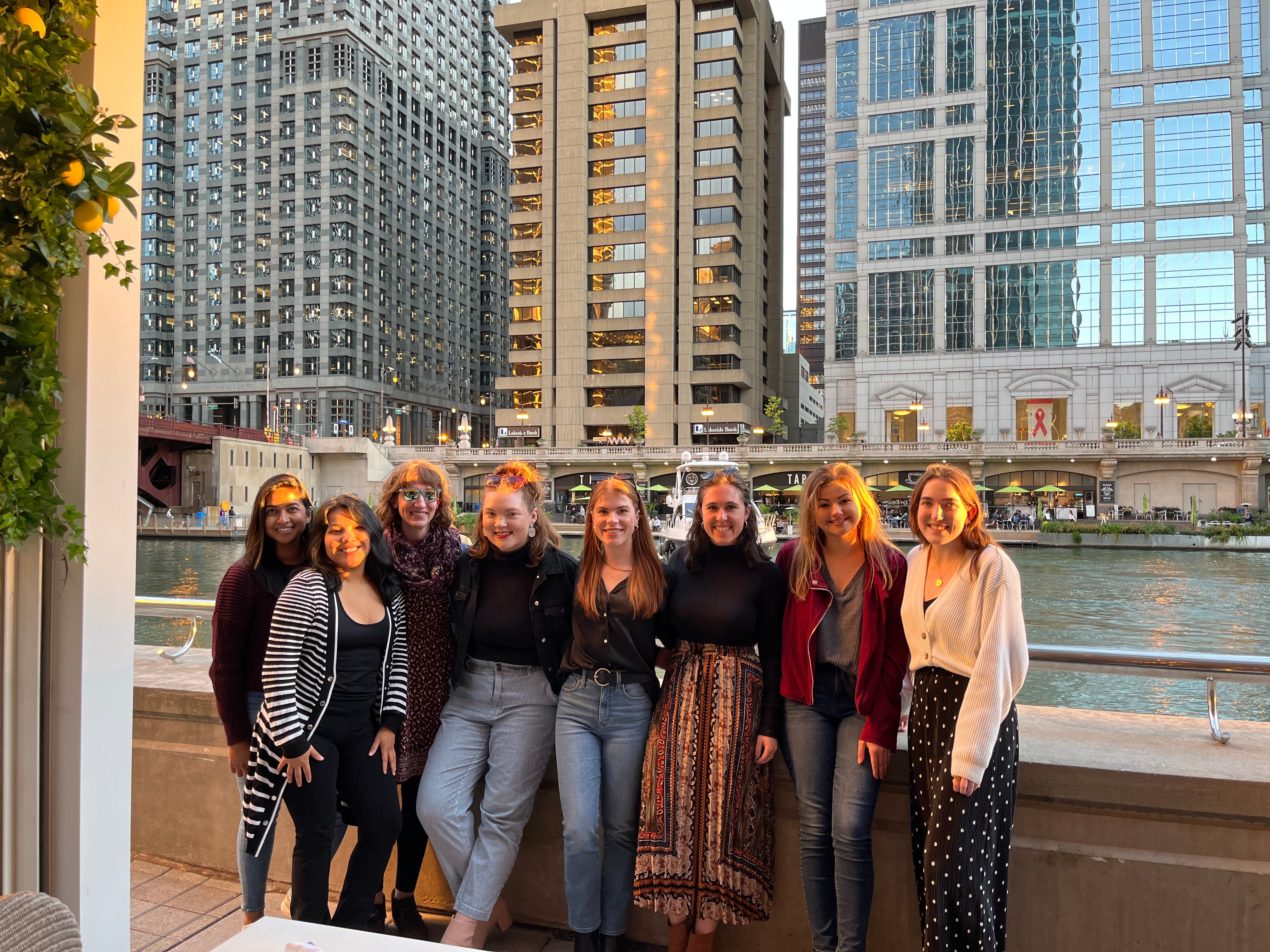 The Tier One Chicago team posing in front of the Chicago River