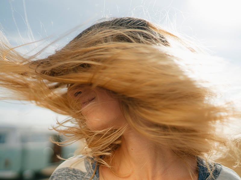 woman's hair blows in the wind