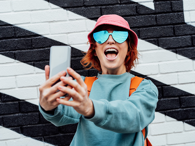 Woman posing with phone for selfie