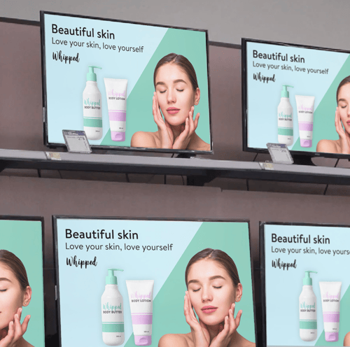 Many screens show an advertisement for skincare products.
