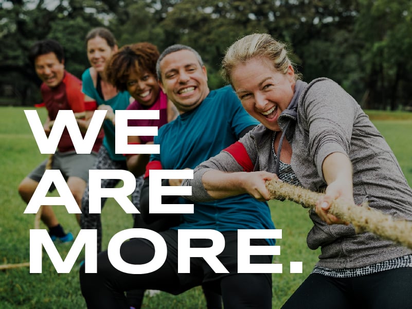 people smiling and playing tug of war