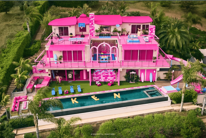 A photo of Barbie's massive pink Dreamhouse from the movie Barbie.