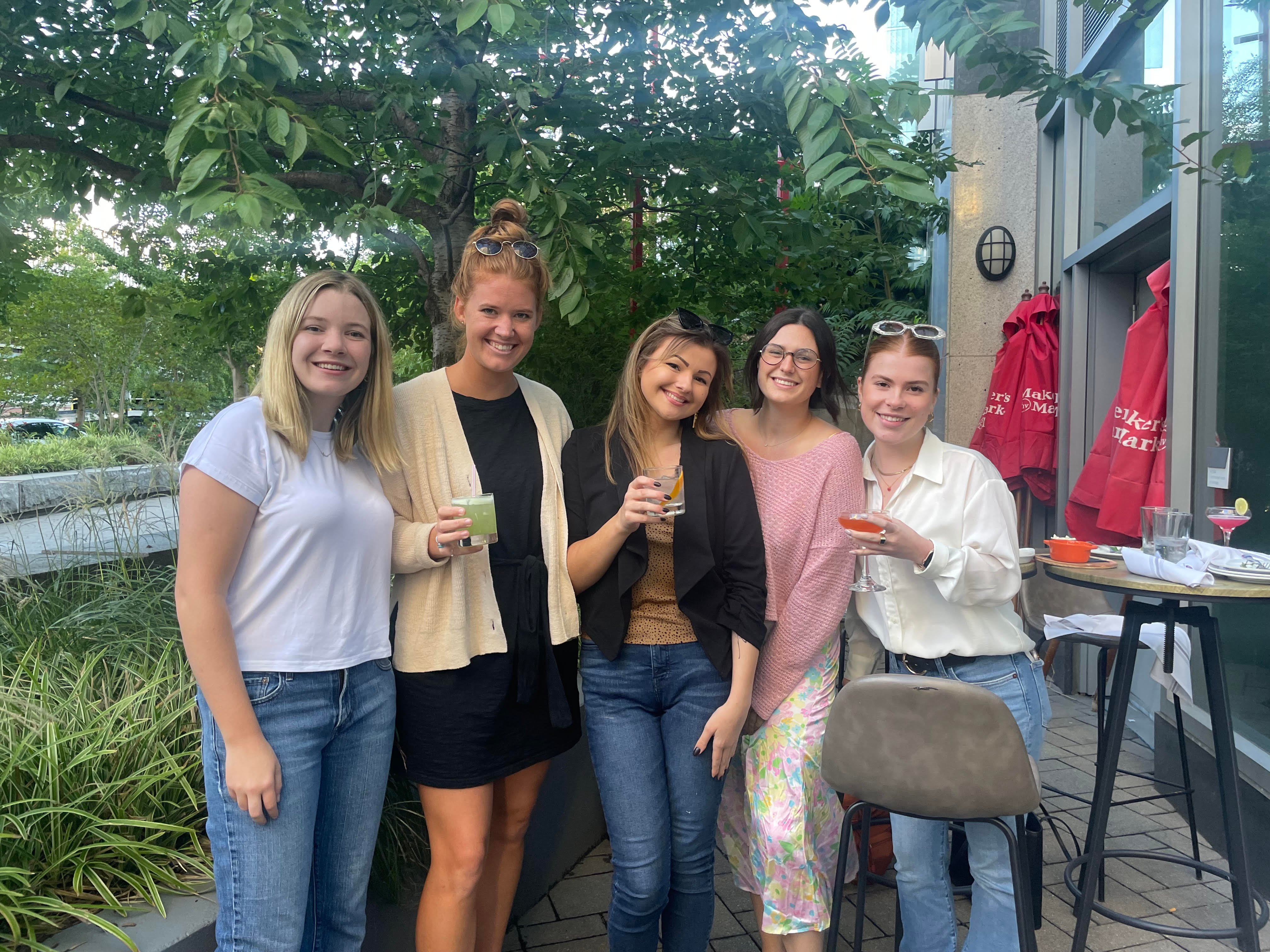 Five Tier One team members at a beer garden in Boston