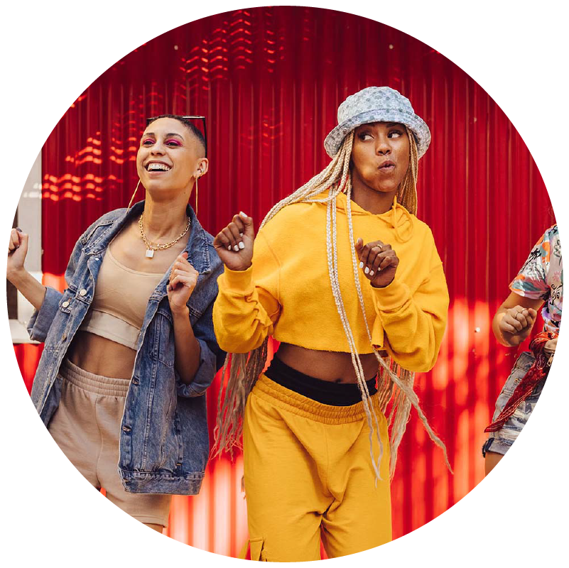 Two people dancing in front of a red background