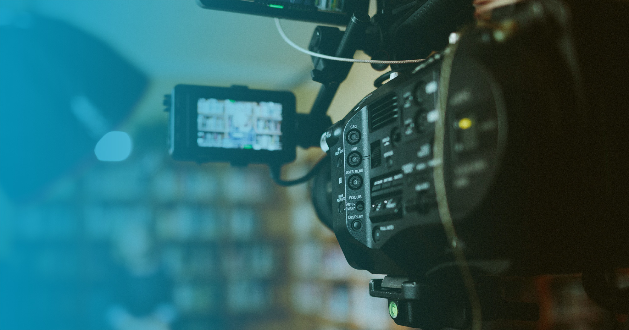 Close up of a news camera recording a reporter