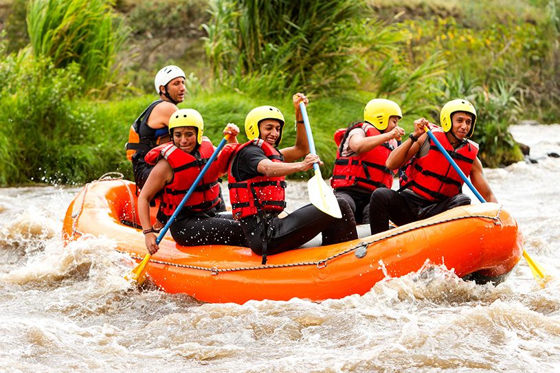 group of people white water rafting